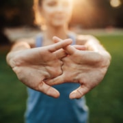 Young woman stretching arms outdoors