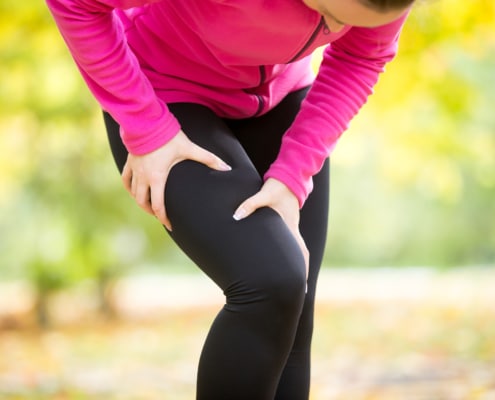 Hands grabbing a hip, sport injury - Colorado Center of Orthopaedic Excellence Hip pain