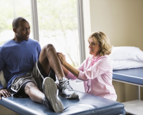 Physical therapist examining patient - Colorado Center of Orthopaedic Excellence Orthopedic Injury
