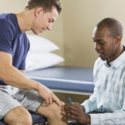 Physical therapist examining patient