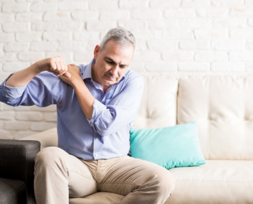 Mature man with shoulder pain at home