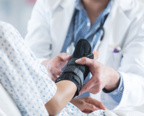 Healthcare professional places brace on patient's arm - Colorado Center of Orthopaedic Excellence Wrist Fracture